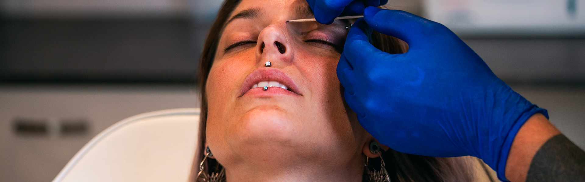 Woman getting pierced